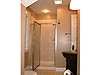 shower with dark bathroom cabinet